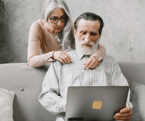 A man and a woman looking at a laptop together